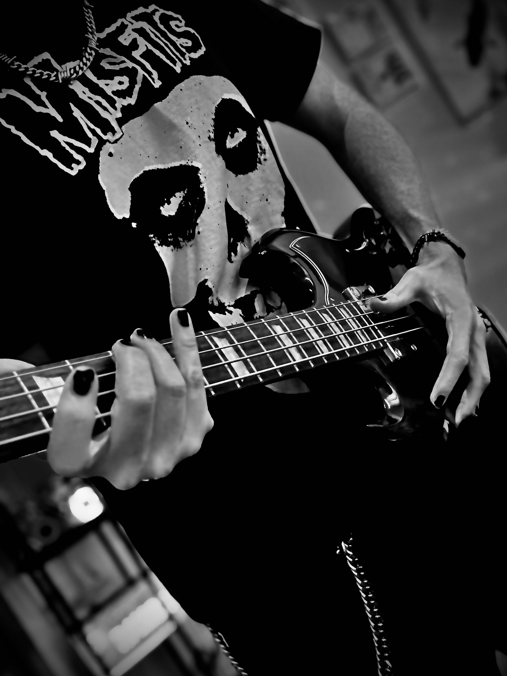 Close-up photo of hands playing bass guitar